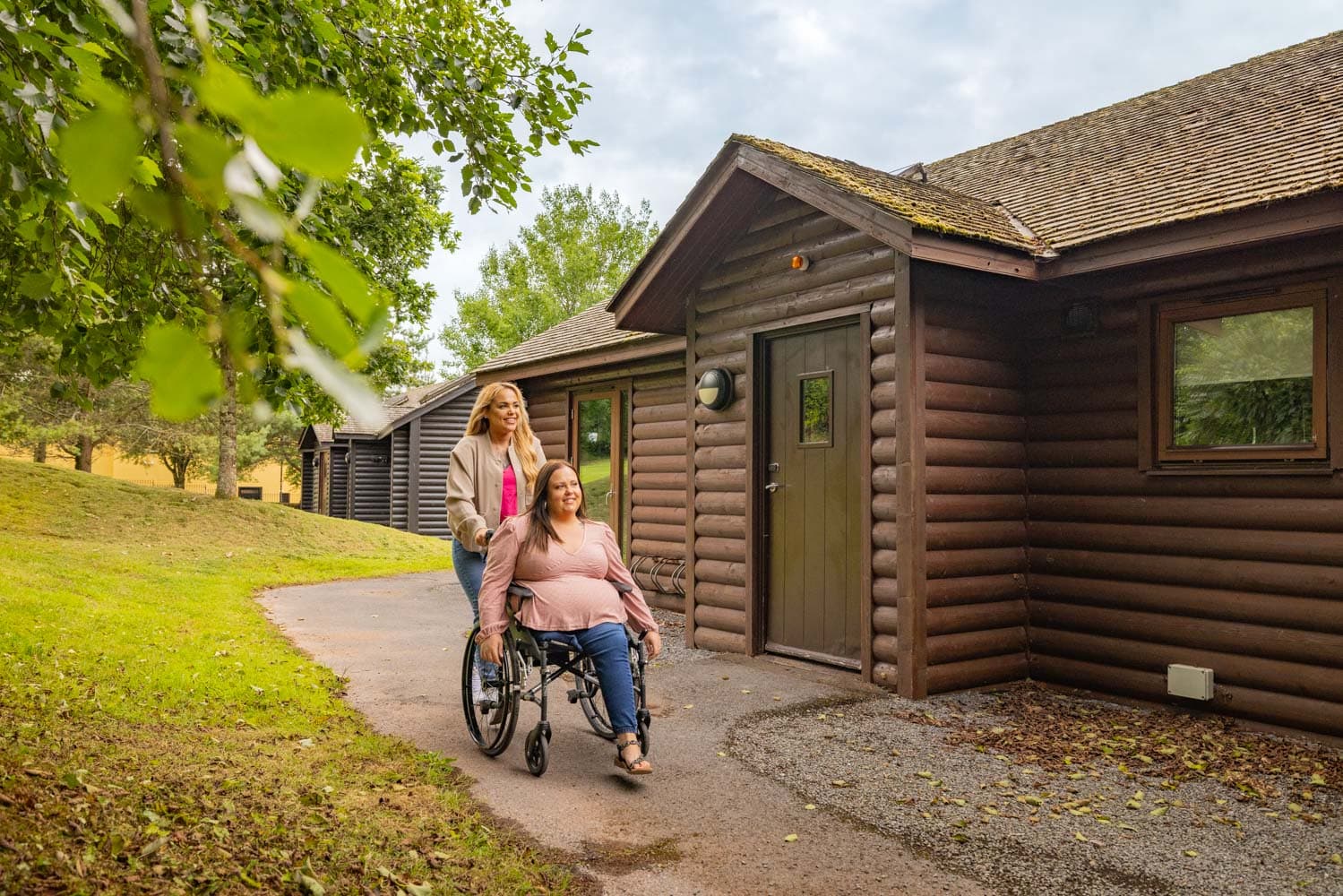 Wheelchair user outside lodge at Bluestone