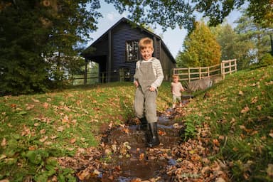 Boys playing outside lodge Autumn