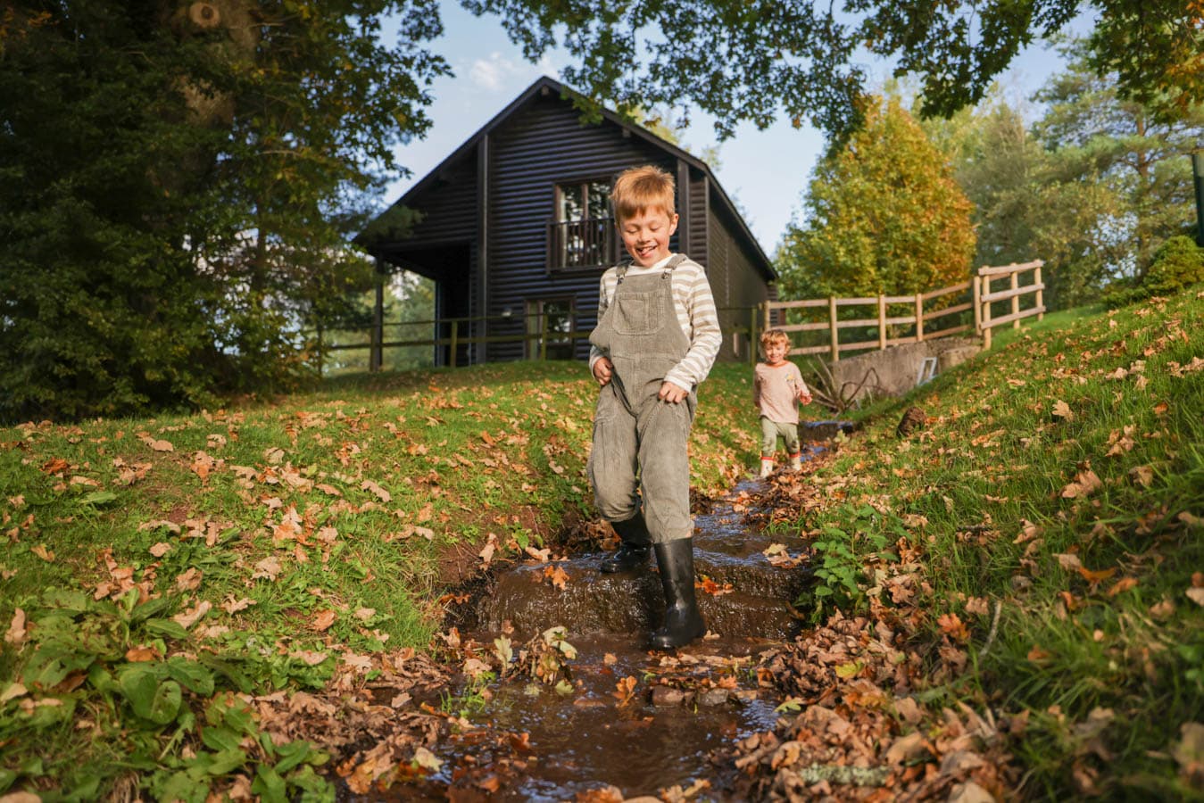 Boys playing outside lodge Autumn