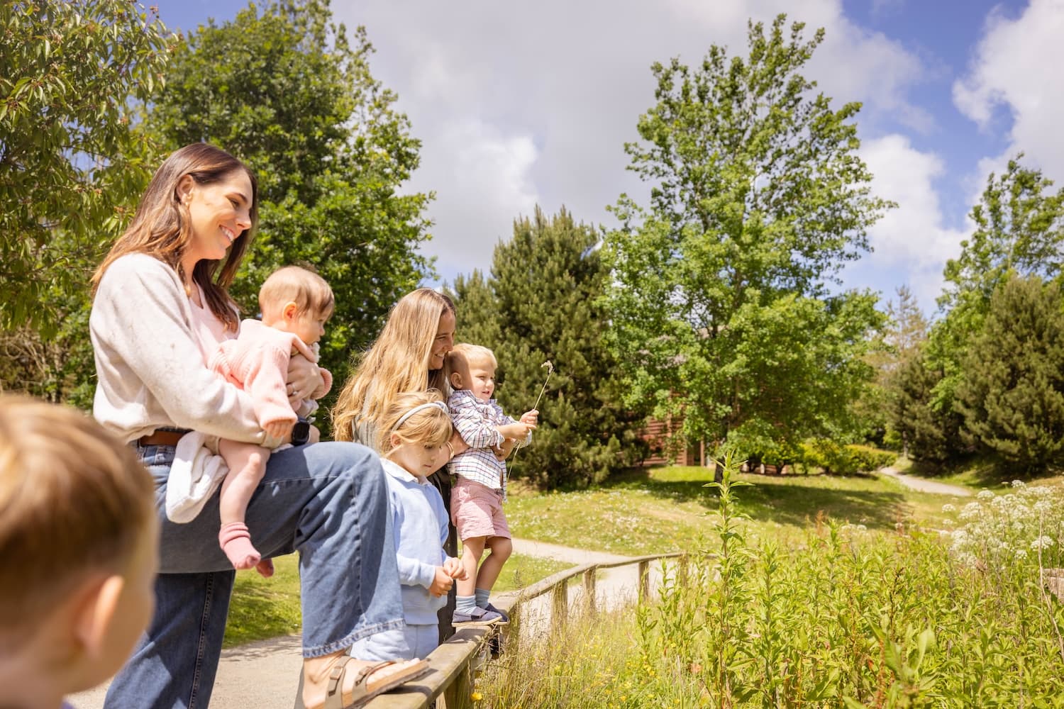 Family With Young Children At The Lake in summer