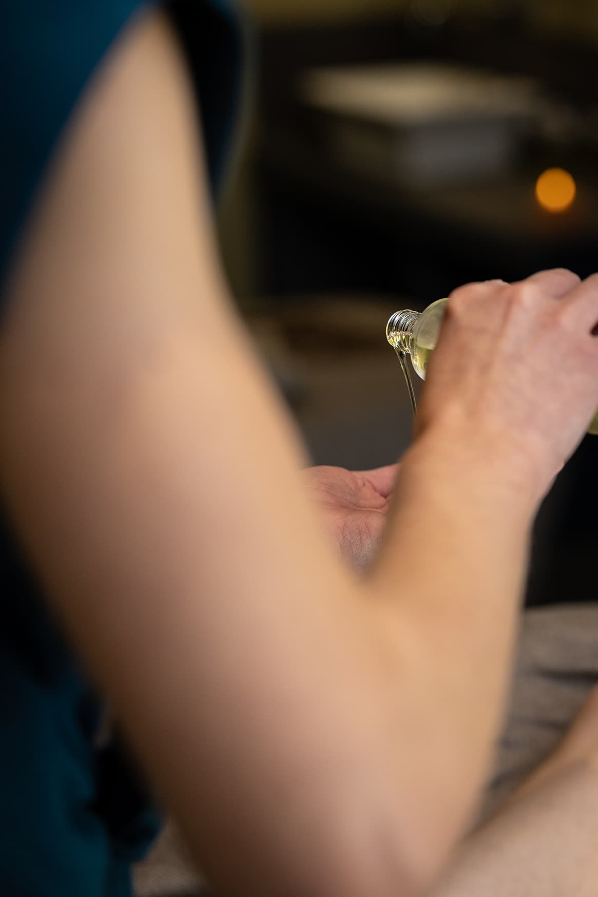 Pouring massage oil into hand