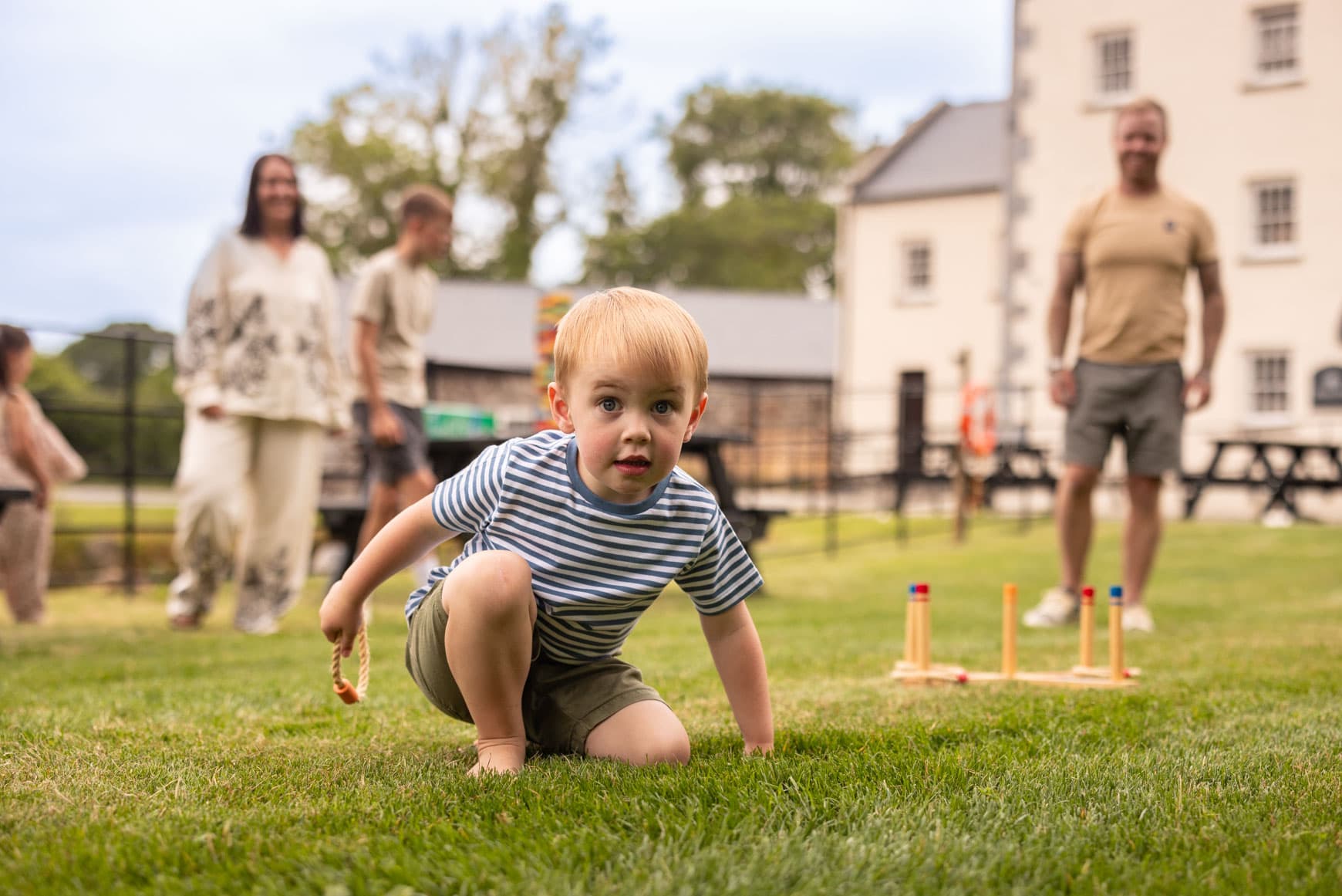 Family Playing Outside Black Pool Mill