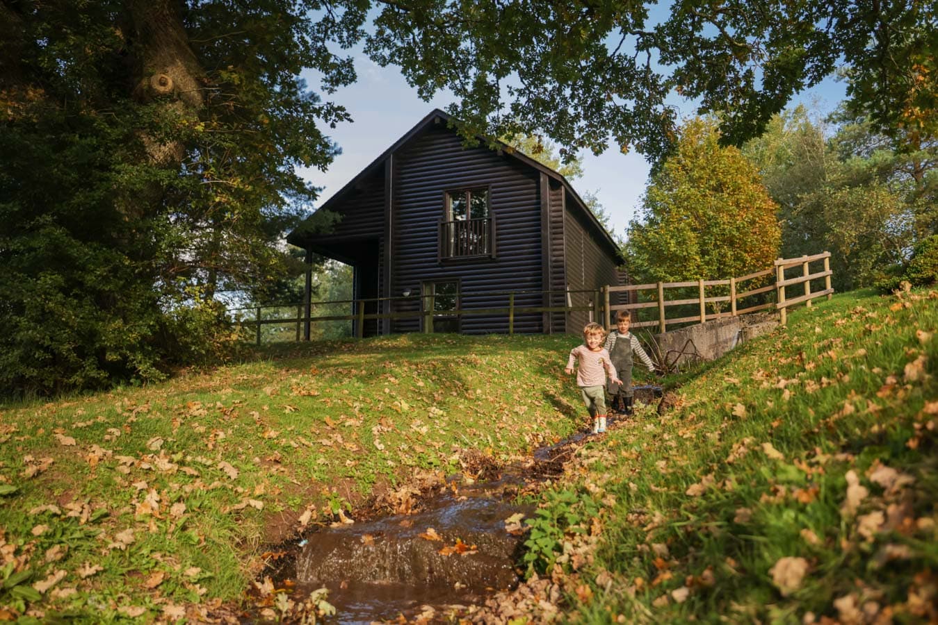 Boys playing outside lodge Autumn
