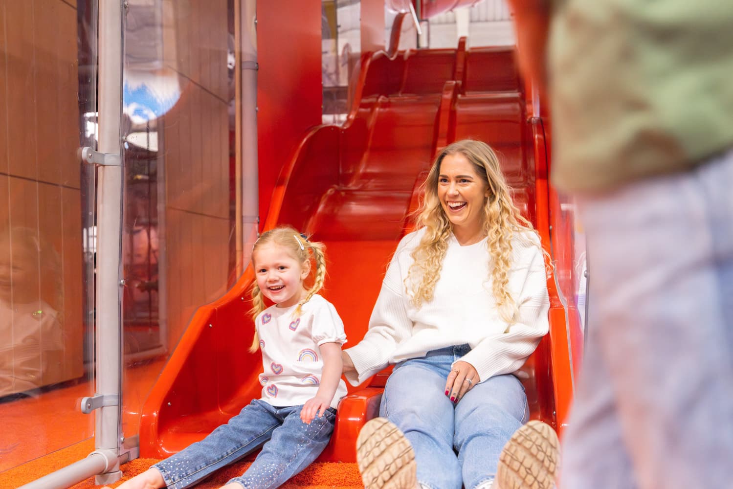 Mum and daughter slide the hive Bluestone