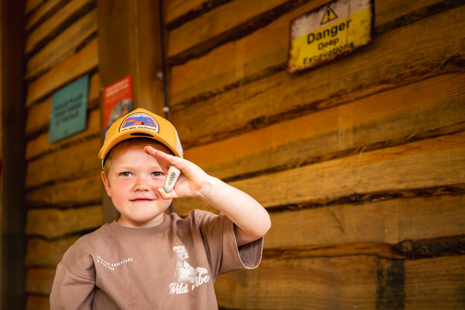 Discovery Den boy with rock at Bluestone
