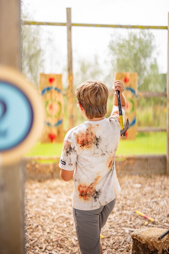 Boy axe throwing, summer at Bluestone