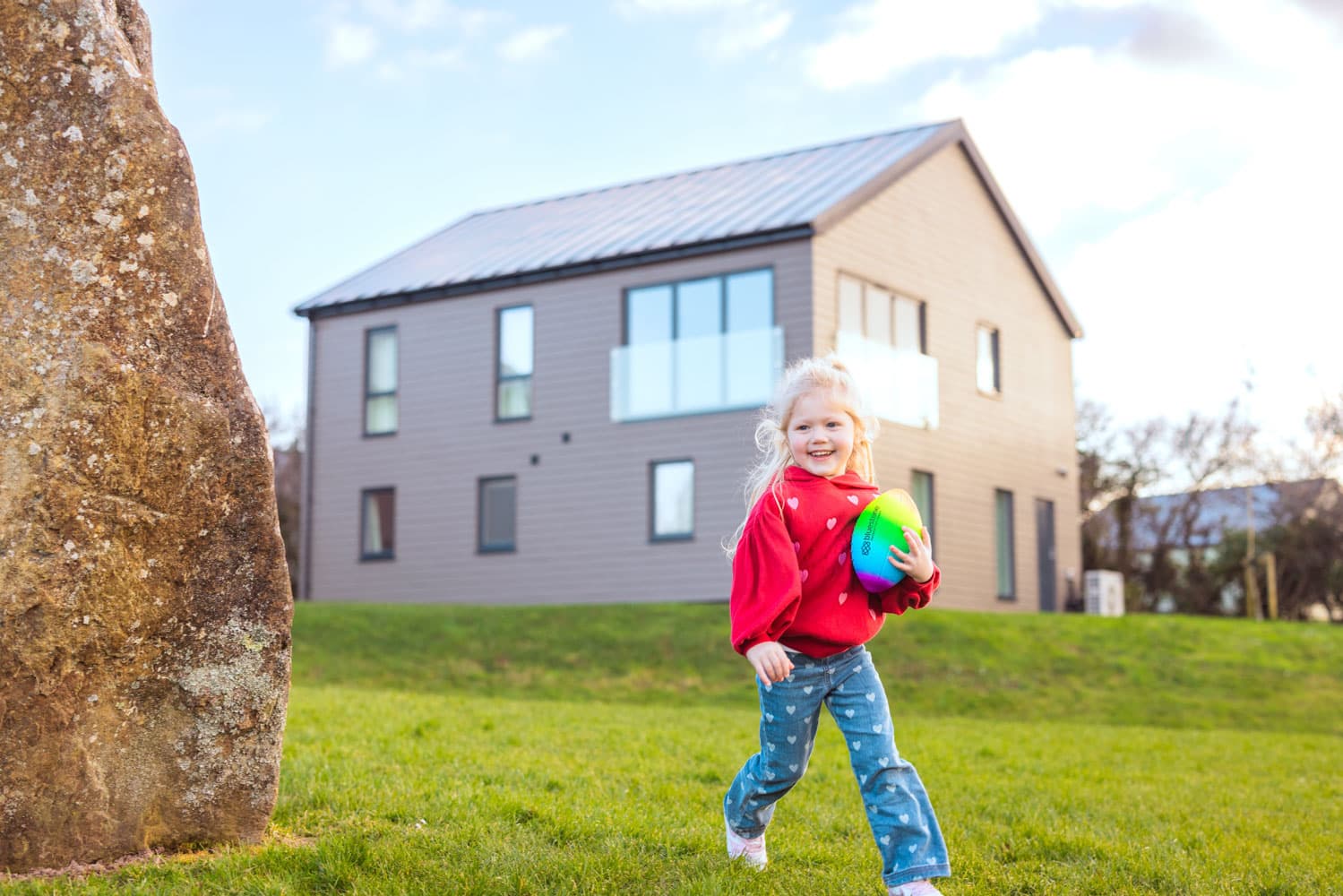 Child playing outside lodge