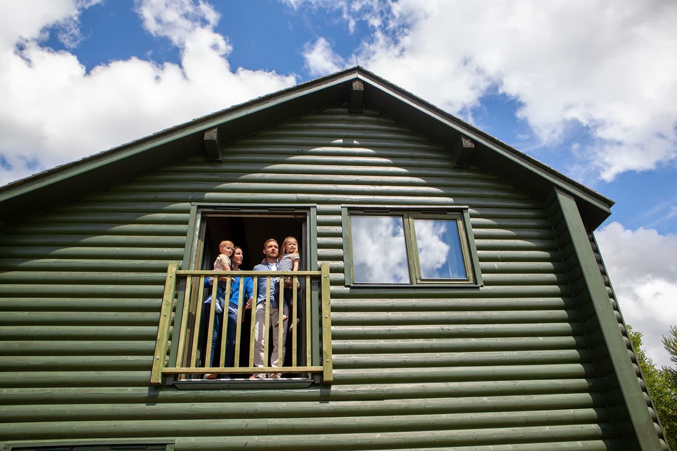 Family Looking Out Of A Ramsey Lodge