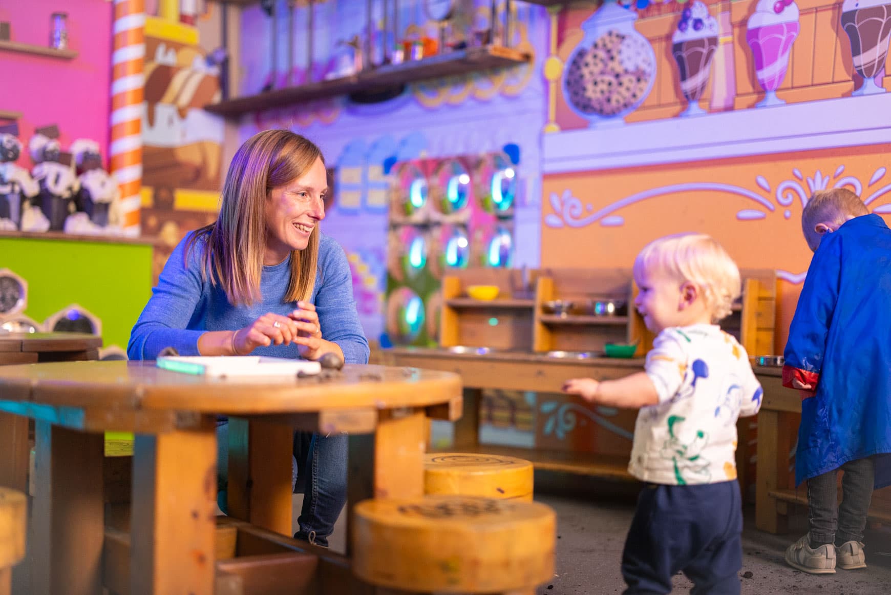 Mum And Child Smiling At Messy Play