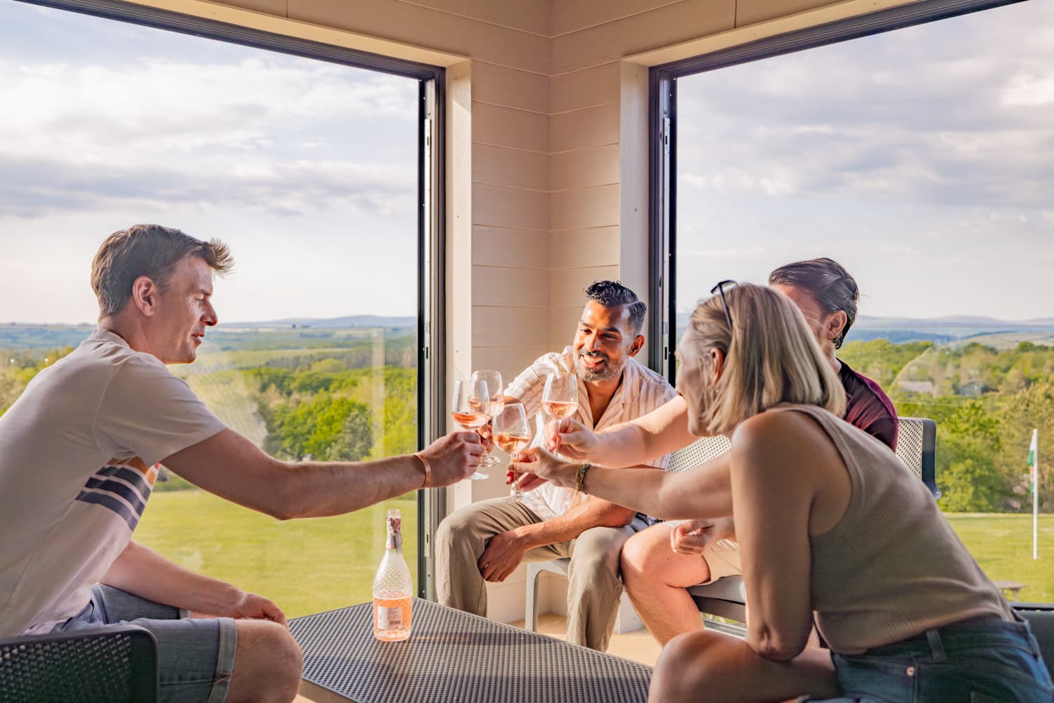 Carningli Lodge friends in sunroom with wine