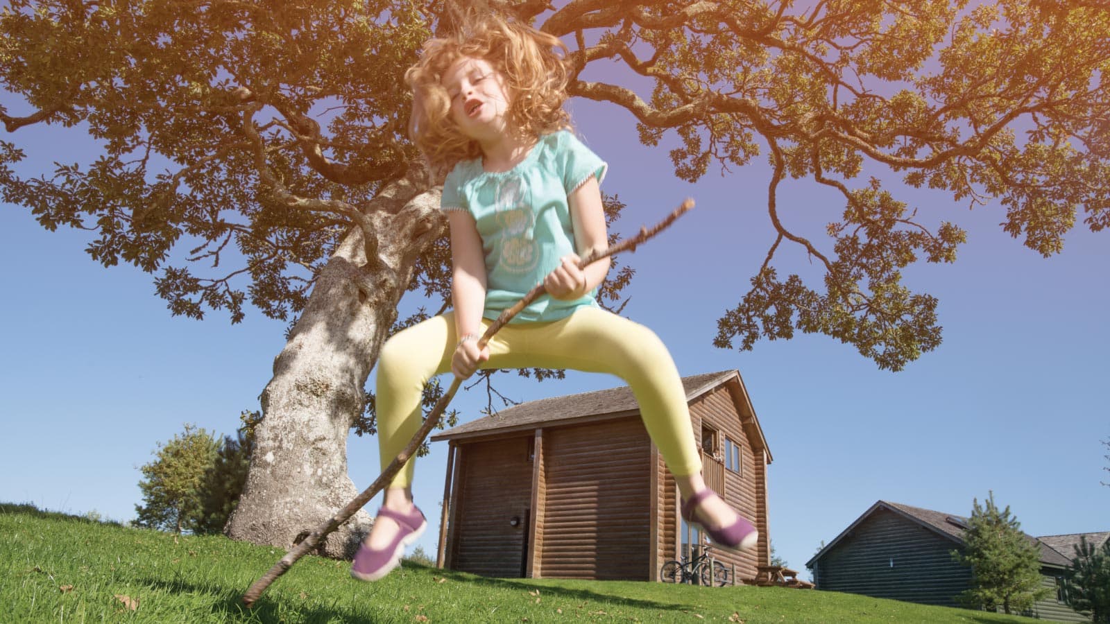 Girl Playing Outside A Lodge In Summer
