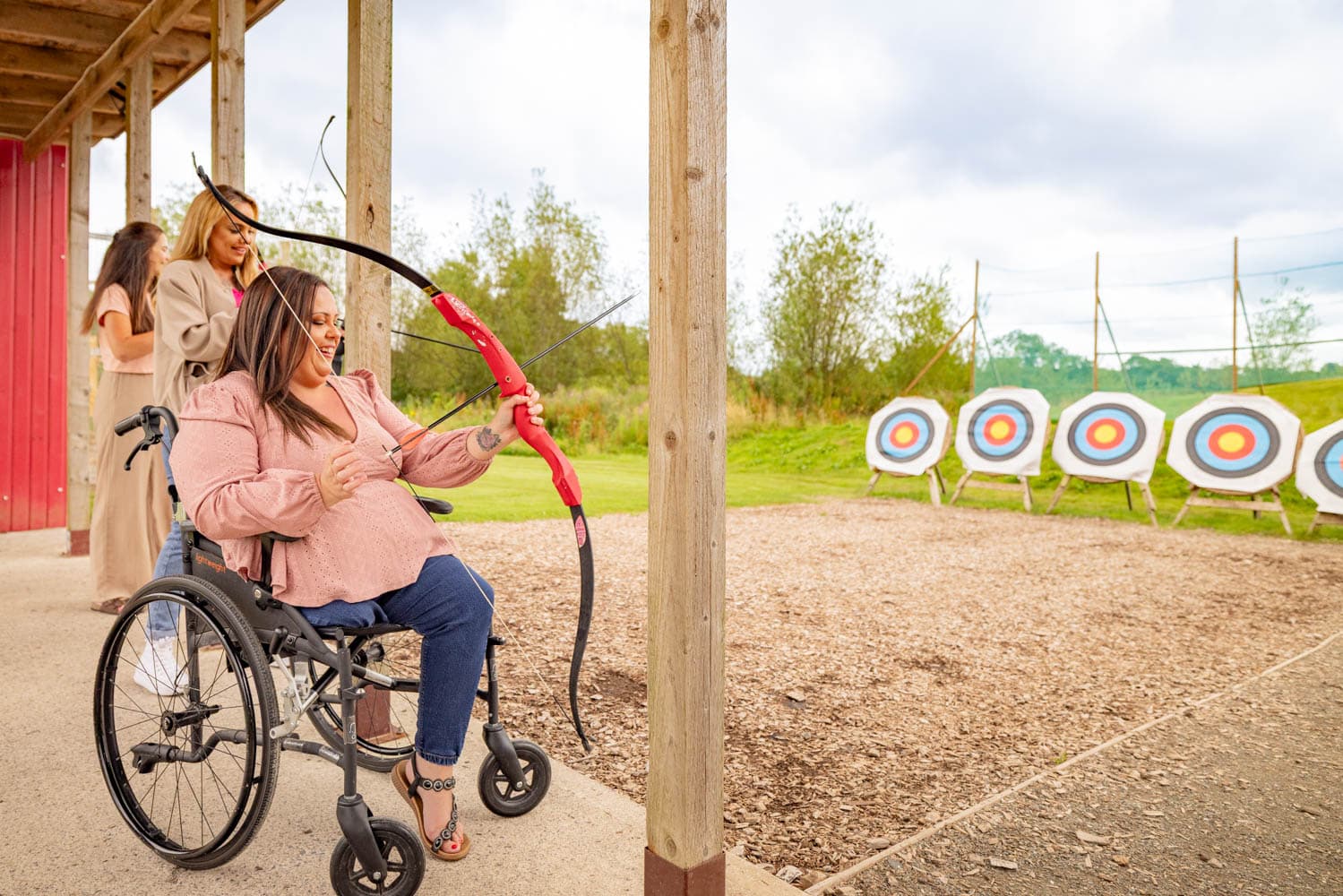  wheelchair user doing archery at Bluestone