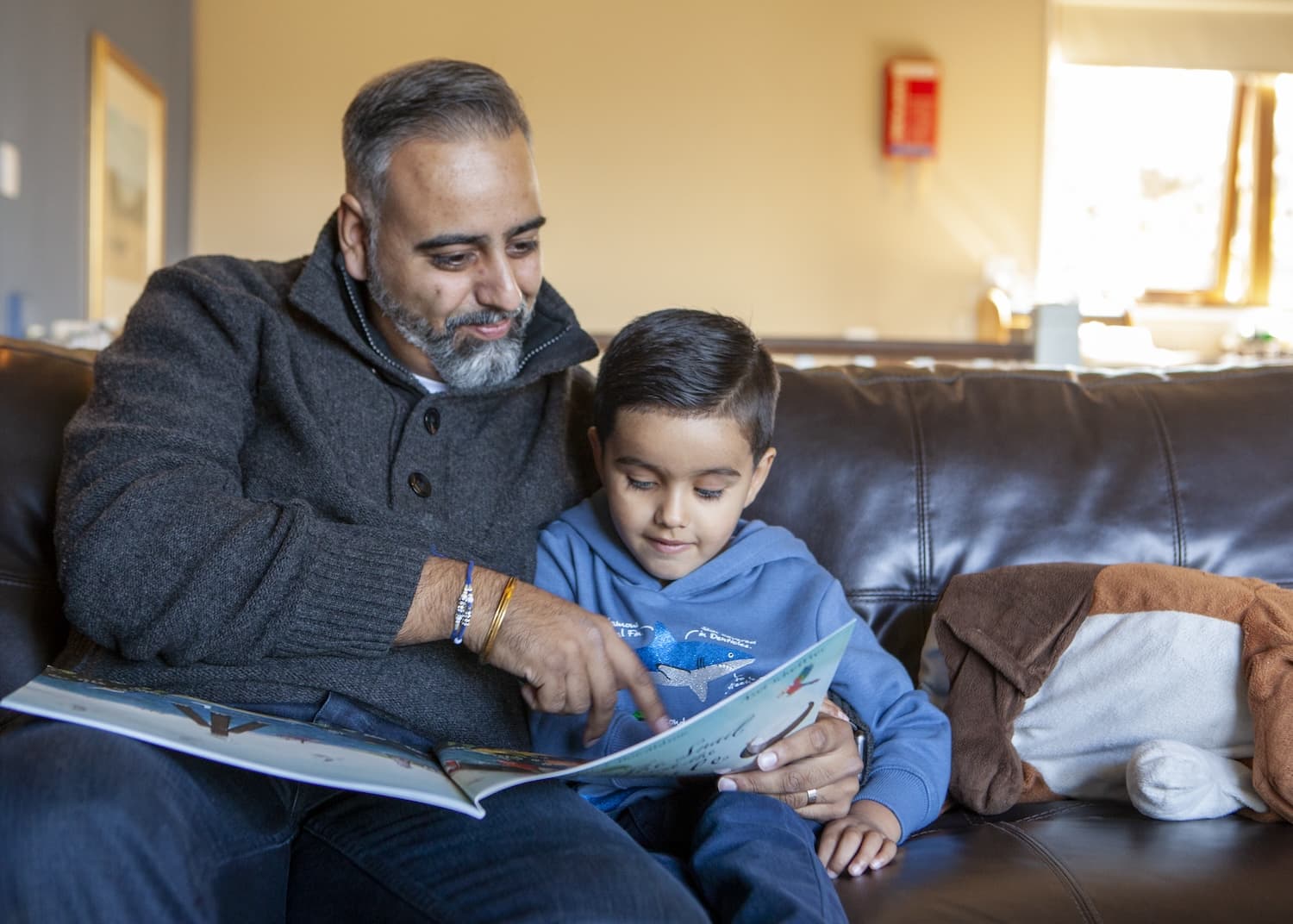 Family Reading In Their Lodge