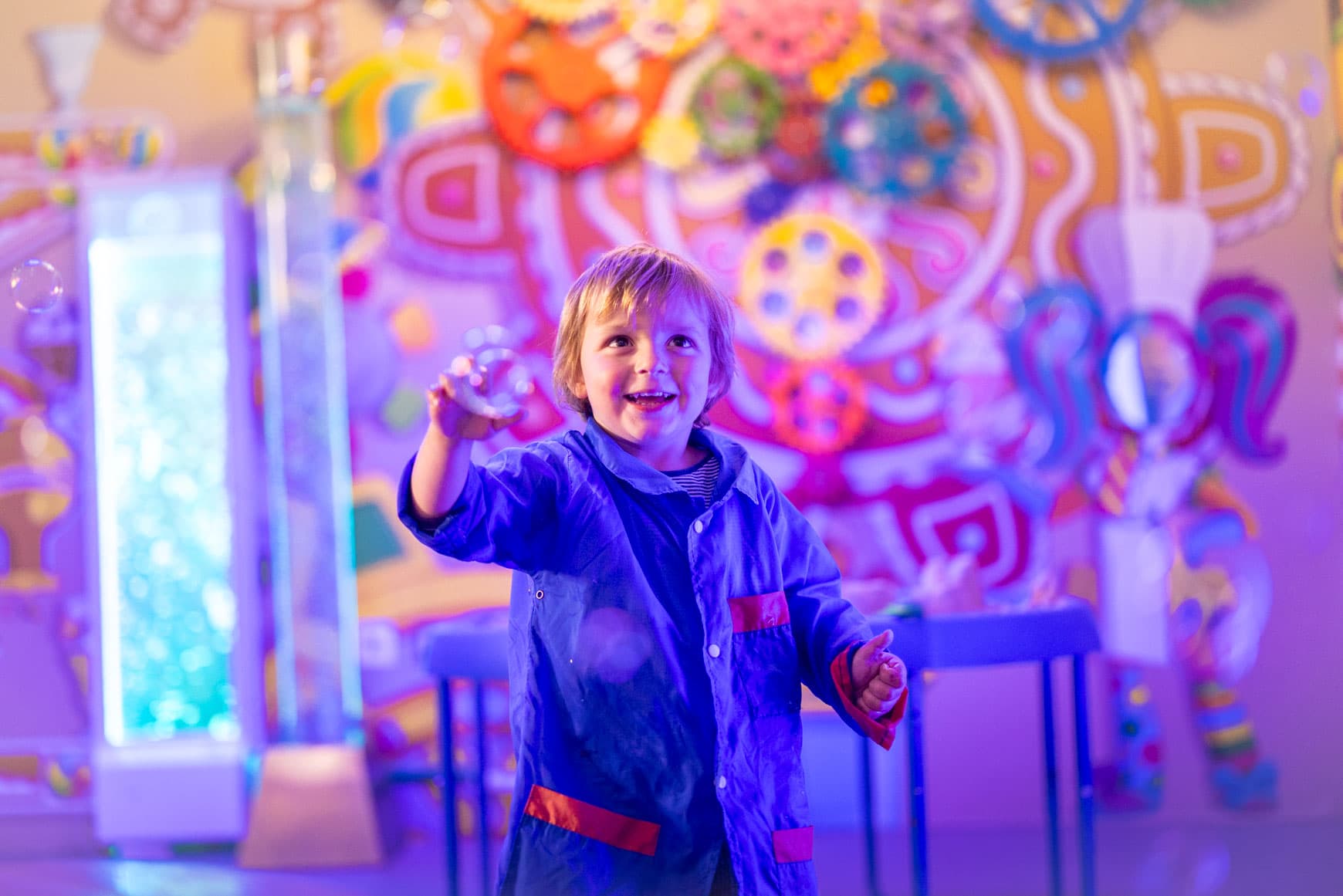 Child Popping Bubbles At Messy Play