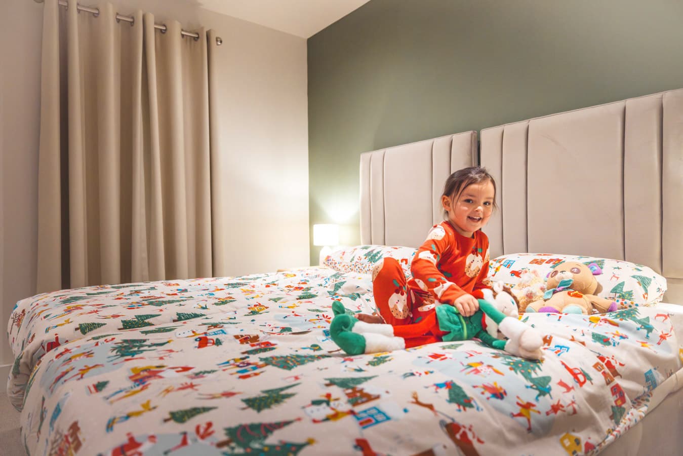 Girl in bed Christmas lodge at Bluestone