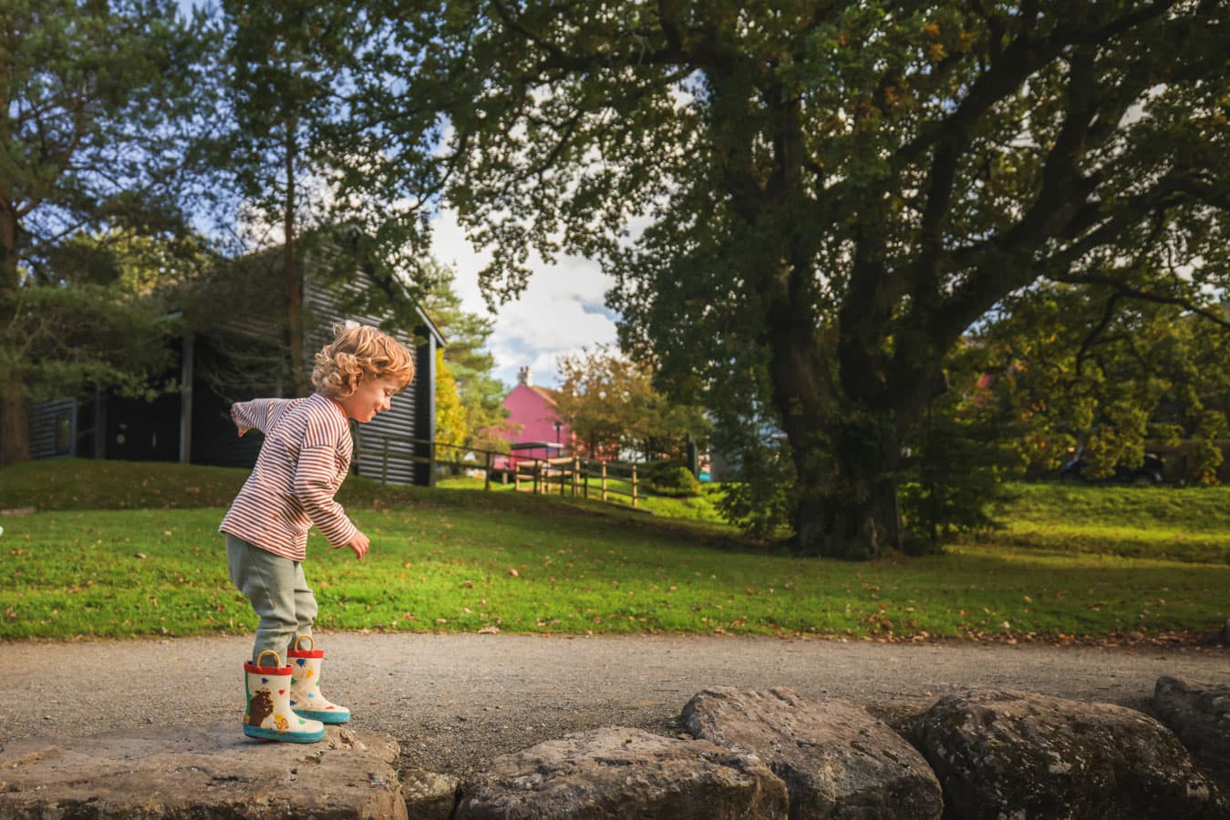 Boy playing outside lodge Autumn