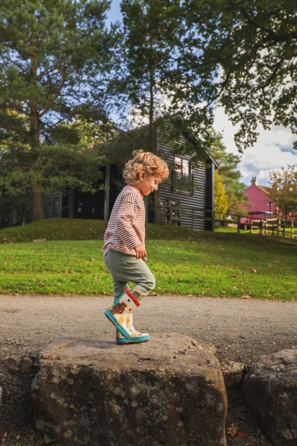 Boy playing outside lodge Autumn