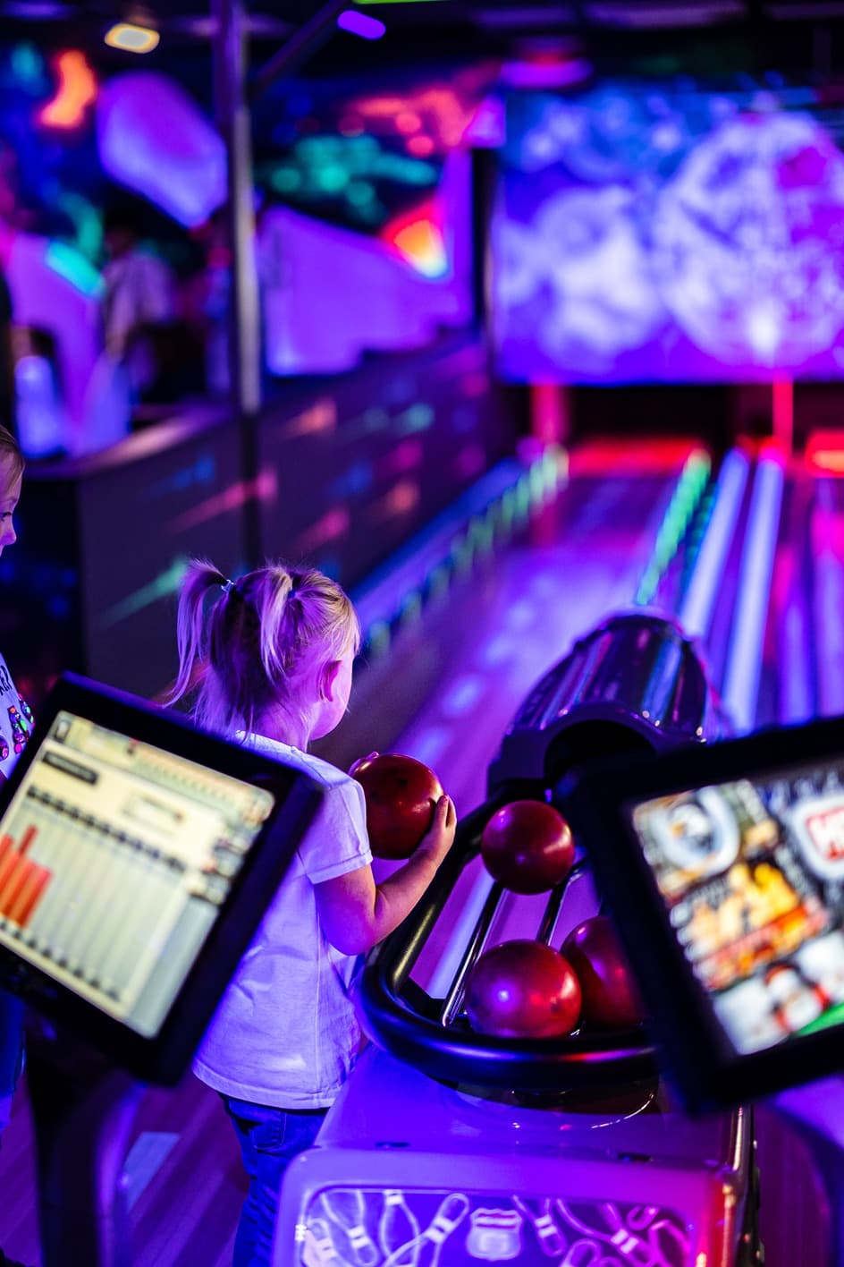 Glowzone Bowling in The Hive gril grabbing ball