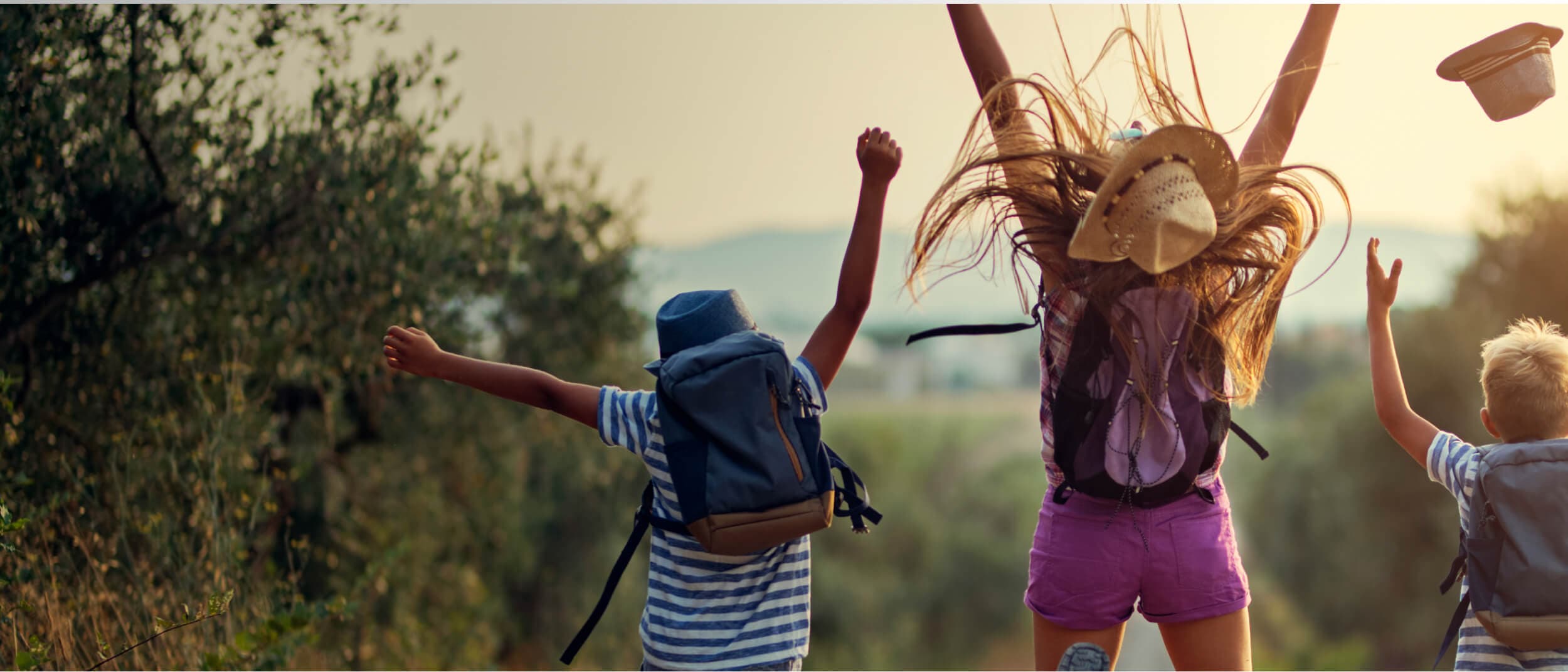 young people jumping with the sunshine in the background