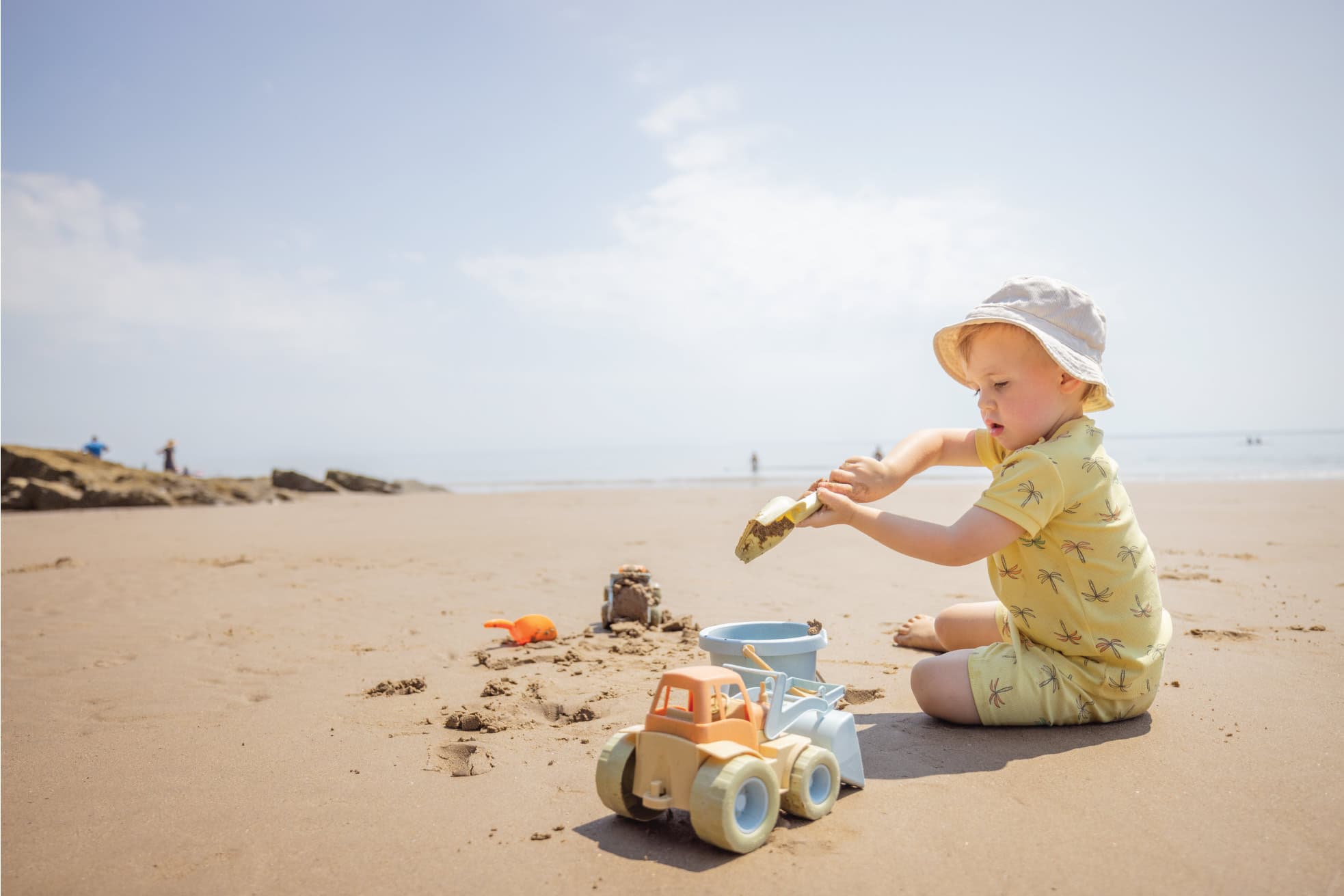 Toddler Playing In Sand At The Beach
