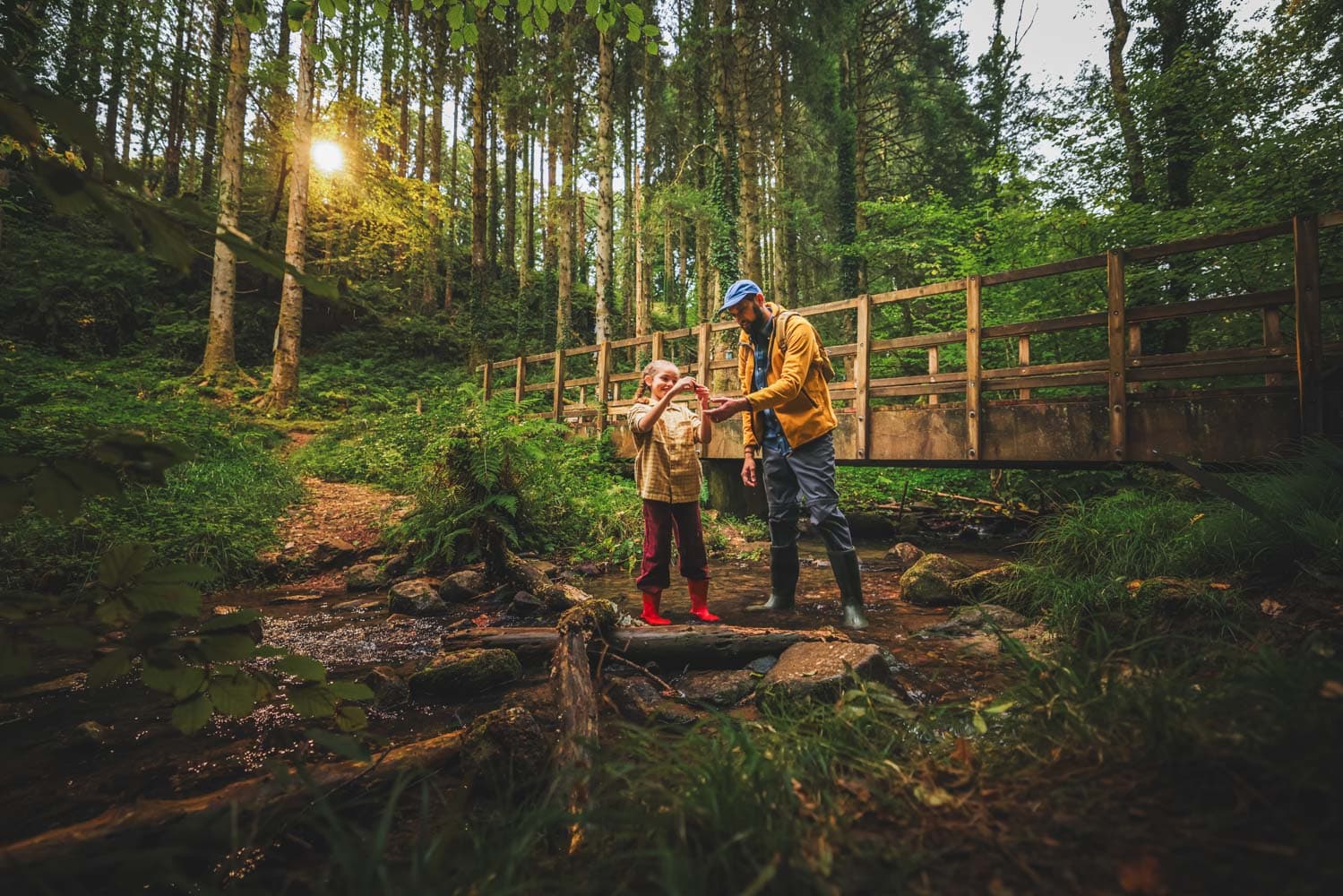Dad & Daughter Playing In Stream On Nature Trail