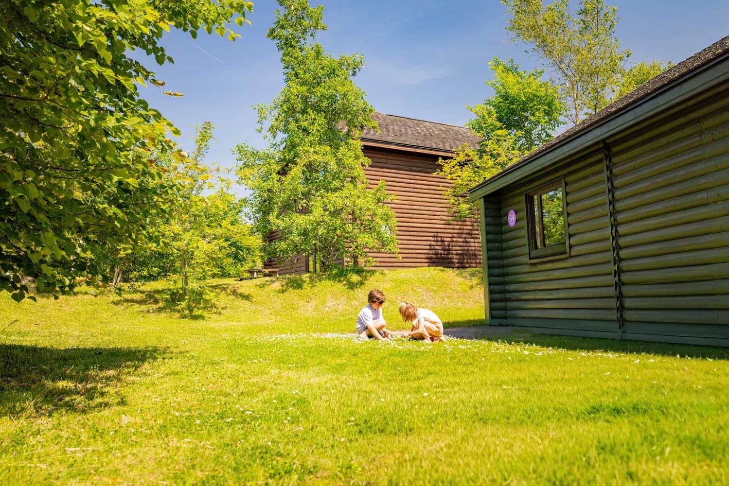 Children playing outside lodge Bluestone