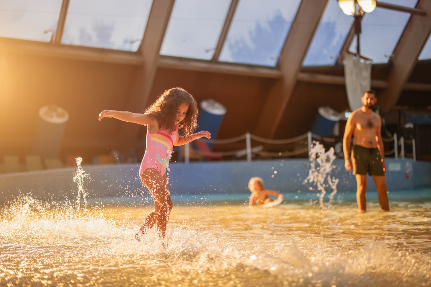 Girl Splashing In Blue Lagoon Shallow End
