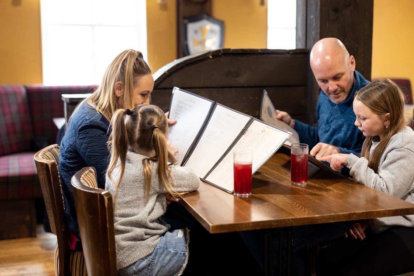 Family looking at menus