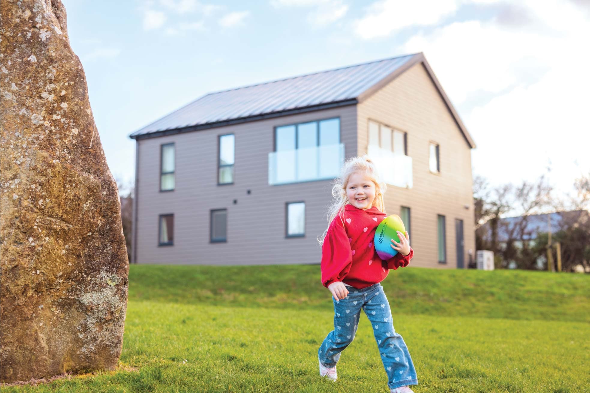 Girl Playing Ball Outside Merlins Crest