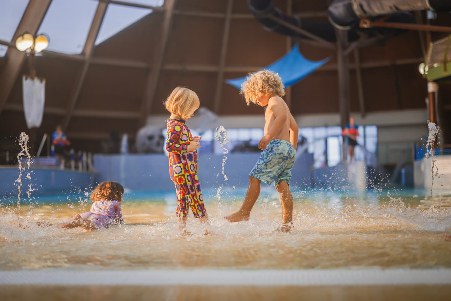 Children Splashing In Blue Lagoon