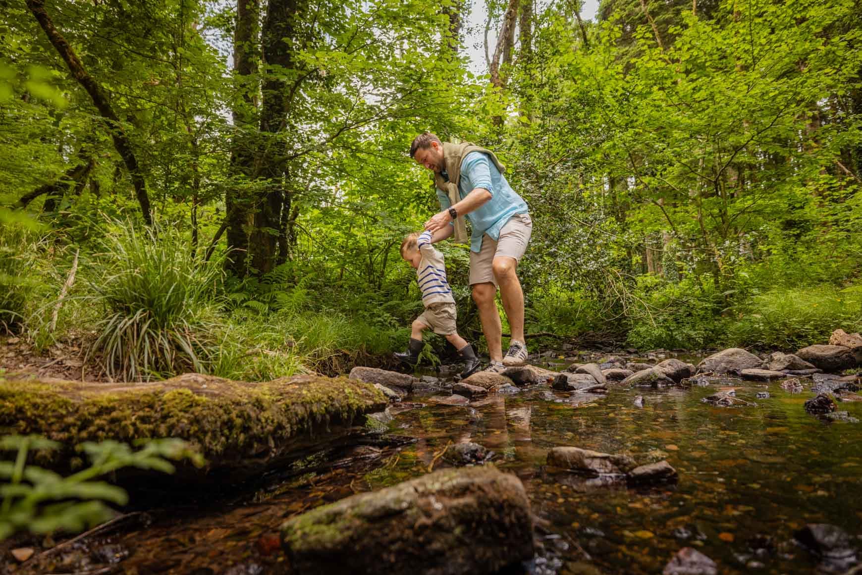 Family Walking On Stepping Stones