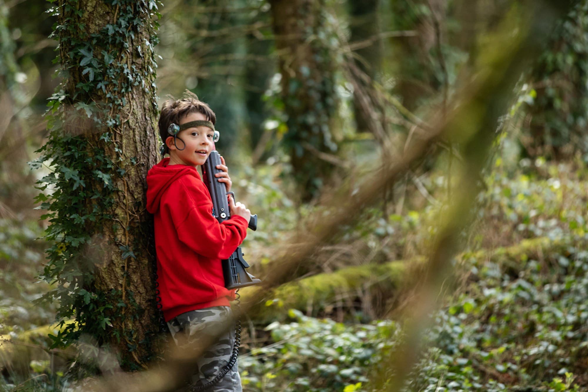 Woodland Warriors Boy Hiding By Tree